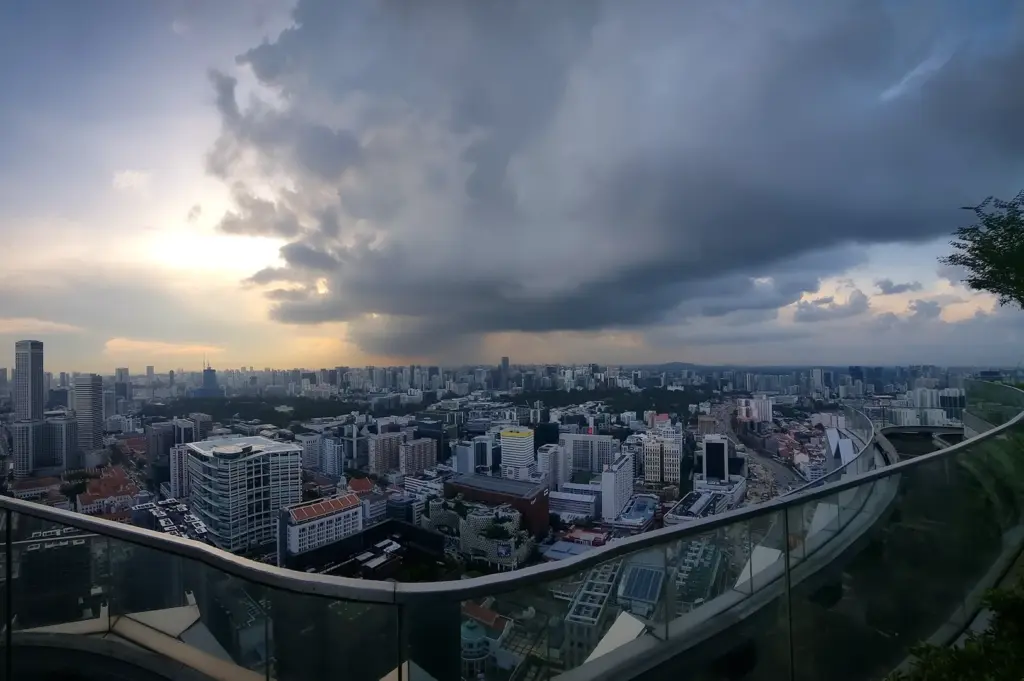Breathtaking twilight view from Mr. Stork at Andaz Singapore, showcasing the iconic teepee huts illuminated with fairy lights amidst manicured rooftop gardens, overlooking the sprawling urban skyline of Singapore at dawn